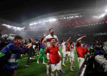 PEMAIN tengah Turkiye Salih Ozcan (tengah) dan Arda Guler menyambut peminat selepas perlawanan bola sepak pusingan 16 UEFA Euro 2024 menentang Austria di Stadium Leipzig, hari ini. - AFP