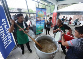 KIRA-kira 60 individu terdiri daripada pelajar, kakitangan Universiti Sains Islam Malaysia (USIM) dan Media Mulia Sdn. Bhd. bergotong-royong menyediakan bubur lambuk sempena Program Kongsi Berkat Bubur Lambuk anjuran Syarikat Mahsuri Dagang Sdn. Bhd. dan Media Mulia Sdn. Bhd. di USIM Nilai, hari ini. UTUSAN/AMIR KHALID