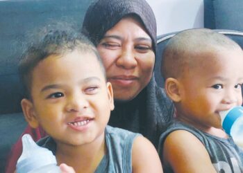 NURUL Darvina Mat Daud bersama  Muhammad Shahiran Dayyan Mohd. Sharon (kiri) yang kini hilang mata kiri akibat kanser mata di rumah mereka  di Kampung Sungai Karang Darat, Kuantan, Pahang.