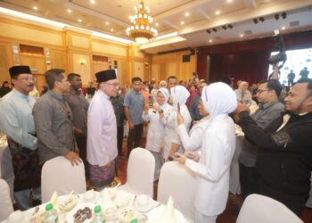 ANWARIbrahim beramah mesra dengan petugas barisan hadapan pada Majlis Berbuka Puasa JPM di Puspanitapuri, Putrajaya. - UTUSAN/FAISOL MUSTAFA